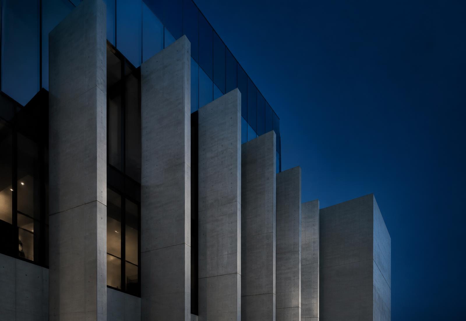 Concrete and glass building facade at blue hour